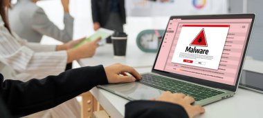 Cyber attacking concept. Malware alert showing on computer screen display scam and threat detection on computer system or online server to be removed snugly.