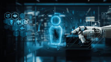 Fütüristik bir robot el modern bir ofiste dijital kullanıcı arayüzüne ulaşarak, yenilikçi iş akışları için teknoloji ve veri güdümlü çözümlerin entegrasyonunu sergiliyor. Auvana