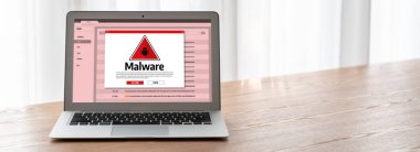 Cyber attacking concept. Malware alert showing on computer screen display scam and threat detection on computer system or online server to be removed snugly.
