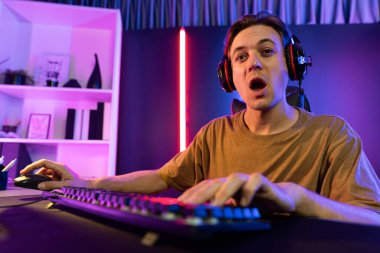 Kazanmak için çevrimiçi oyun oynayan akıllı flama makinesinin sunucu kanalı, neon ışıklı odada seçilen takım yarışması için izleyicilerle birlikte canlı yayında canlı yayında kulaklık takıyor. Bireysel.