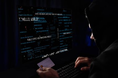 Suçlu anonim erkek, gece vakti mavi neon ışıklı odada sunucu sürücüsü ile şifre kırma programı kodlamak için kişisel bilgi veritabanının kredi kartına yaklaşıyor. Tahmin et..
