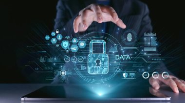 Dijital bir kilide uzanan ellerin kavramsal bir görüntüsü, soyut arayüz elementleriyle modern, yüksek teknolojili bir ortamda veri koruması ve siber güvenliği tasvir ediyor. Dörtgen