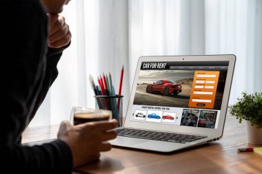 car rental website on computer screen for tourist to rent a car for transportation snugly