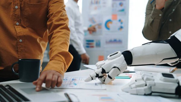 This image showcases a dynamic collaboration between human and robot in a modern office, highlighting teamwork, technology, and data analysis for productivity and innovation.Noogenesis