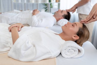 Kafkasyalı çift stres önleyici kafa masajının keyfini çıkarıyor ve lüks otellerde ya da otel spa salonlarında gündüz kaplıcalarında yüz güzelliği eğlencelerini şımartıyor. Sessiz.