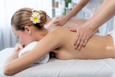 Kafkas çift müşterisi stres önleyici spa masajının keyfini çıkarıyor ve lüks otel veya oteldeki gündüz açık hava ortamında güzellik teniyle eğleniyor. Sessiz.