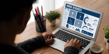 Human resources management software on computer screen helping human resources employee to manage recruitment, payroll, staff searching and KPI evaluation snugly