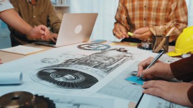 Bir mühendislik ekibi modern bir ofiste teknik çizimler ve tasarımlar üzerinde işbirliği yapıyor. Sahne yaratıcılığı, takım çalışmasını ve yenilikçi problem çözmeyi iş başında tasvir ediyor. SACTR