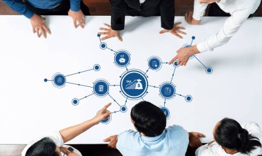 Çeşitli bir ekip, modern bir tablodaki görsel veri noktalarını analiz ederek finansal planlama ve vergi stratejilerine odaklanan stratejik bir toplantıda işbirliği yapıyor. Dostluk