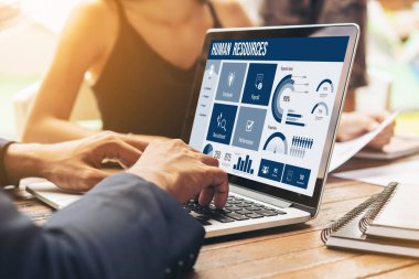 Human resources management software on computer screen helping human resources employee to manage recruitment, payroll, staff searching and KPI evaluation snugly