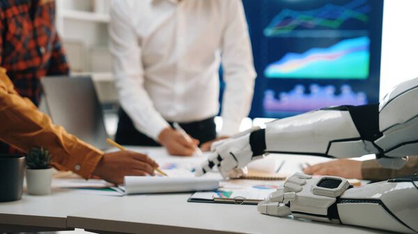 A unique scene showcasing collaboration between a robot and humans in an office setting, highlighting teamwork in analyzing data trends with charts and documents.Noogenesis
