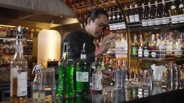 Asyalı barmenin karışık kokteyl likörünü likör karışımına katması, özel reklamı yaratıcı, canlandırıcı, bar lüksünde canlandırıcı bir vitrin haline getiriyor. Vinosity.