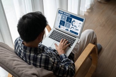 Human resources management software on computer screen helping human resources employee to manage recruitment, payroll, staff searching and KPI evaluation snugly