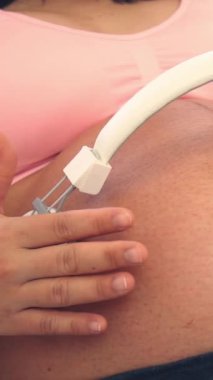 Hamile bir kadın çocuğuna bakarken kendini mutlu hissediyor. Hamile karnında bebek taşıyan hamile bir anne. Doğum öncesi bakım ve kadın hamileliği konsepti.