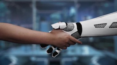 Bir insan eli robotik bir elle birleşmek için uzanıyor, işbirliğine olan bağlılığını vurguluyor, gelecekteki bir ortamda dijital bir işaretle destekleniyor. Auvana