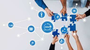 Eller bulmaca parçalarını bir araya getirmek için birlikte çalışarak, yenilik ve takım çalışmasını vurgulayarak, modern bir iş bağlamında işbirliği ve çevik yöntemleri sembolize ediyorlar. Dostluk