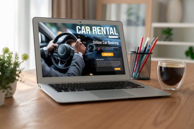 car rental website on computer screen for tourist to rent a car for transportation snugly