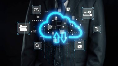 Takım elbiseli bir işadamı bulut teknolojisinin görsel temsili önünde duruyor, veri transferi ve çevrimiçi depolama için dijital simgeler sergiliyor. Dörtgen