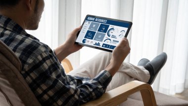 Human resources management software on computer screen helping human resources employee to manage recruitment, payroll, staff searching and KPI evaluation snugly