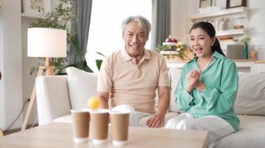 Mutlu yaşlı çift evde birlikte top atmaktan zevk alıyor, sağlıklı yaşlanma için koordinasyon ve bilişsel beceriler geliştiriyorlar. Büyükbabam ve büyükannem klozete pinpon oynuyorlar. Myrmidon.