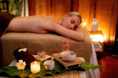 Lüks spa salonlarında sıcak mum ışığında cilt bakımı yaptıran kadın müşteri. Sağlık Spa vücut fırçasında tuz temizleme güzellik tedavisi. Sessiz.