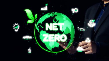 Bu görüntü, gelecek için sürdürülebilirliğin önemini vurgulayarak, teknoloji ve yenilenebilir kaynaklar yoluyla net sıfır emisyon elde etme vaadini temsil etmektedir. Dörtgen