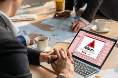 Cyber attacking concept. Malware alert showing on computer screen display scam and threat detection on computer system or online server to be removed snugly.