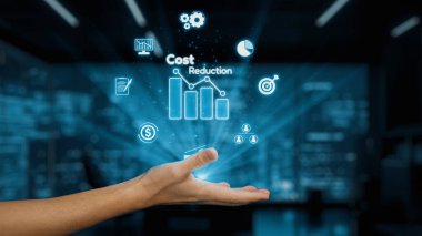 Bir el, bulanık bir iş geçmişine karşı grafiklerin dijital simgeleri ve finans sembollerinin yer aldığı maliyet azalmasının görsel bir temsilini sergilemek için uzanır. Auvana