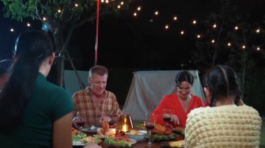 Family together for holiday celebration in garden. Family member gather have dinner. Outdoor picnic activity to relax with food and spend time with cute relatives cross generation gap. Divergence.