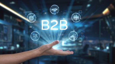 Dijital B2B simgelerine uzanan bir el günümüz modern çalışma alanındaki iş stratejileri ve teknoloji arasındaki bağlantıyı sembolize ederek işbirliği ve büyümeyi vurgular. Auvana