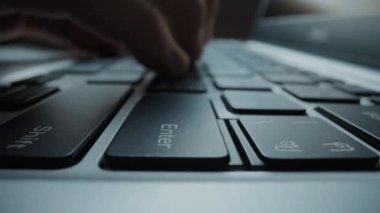 Close-up man typing on computer keyboard with hands and fingers. Macro soft focus dolly shot. Computer programming, text chat online messaging and online marketing business concept. Glean