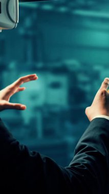 Engineer use cybernated robotic software to control industry robot arm in factory . Automation manufacturing process controlled by specialist using IOT software connected to internet network .