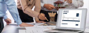 İç mimar tasarımcı grubu, daha kesin tasarım için planlar ve dizüstü bilgisayar ekran mimari yazılımı üzerinde birlikte tartışıyorlar. Modern ev tasarımı ve yenileme. İçgörü