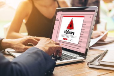 Cyber attacking concept. Malware alert showing on computer screen display scam and threat detection on computer system or online server to be removed snugly.