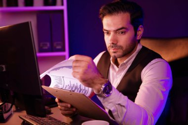 Ciddi derecede zeki bir işadamı, satış kanalı disiplinlerini analiz eden dosya raporu sunar. Neon karanlık ışık odasındaki bilgisayar ekranındaki hedef müşteri grafiğini karşılaştırır. Tahmin et..