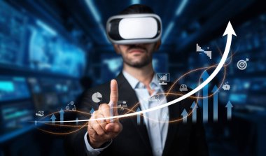 Bu resim, sanal gerçeklik teknolojisini kullanarak finansal büyüme grafiklerini kullanan, analizini ve stratejik yatırım yönetimini geliştiren profesyonel bir adamı gösteriyor. XDMCP