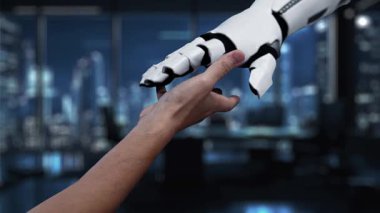 Modern çalışma alanındaki dijital simgelerle çevrili holografik bir insan figürüne uzanan bir elin detaylı bir görüntüsü gelişmiş teknoloji ve yenilik sergiliyor. Auvana