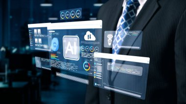 Bir işadamı, iş dünyasının başarısı için yenilik ve teknoloji entegrasyonunu vurgulayarak, çağdaş bir ofiste yapay zeka veri analizleri sergileyen ileri dijital arayüzlerle ilgileniyor. Dörtgen