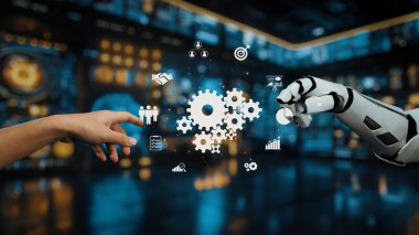 Bu resim, dijital ortamda bir insan ve robot el arasındaki etkileşimi, dişlileri ve veri görsellemesini, yeniliği ve işbirliğini sembolize eden etkileşimi tasvir eder. Auvana