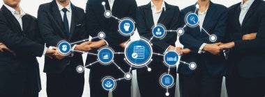 Takım elbiseli bir grup iş adamı, çeşitli teknoloji simgeleri ve kurumsal bir ortamda veri paylaşımı ve işbirliğini temsil eden bağlantı sembolleri sergileyerek bir arada duruyorlar. Dostluk