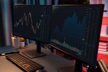 Dinamik borsa grafiklerinin büyük ekranları neon ışıklı gece vakti bilgisayarda görünüyor. Finansal teknolojiye yapılan güncellenmiş yatırımla otomatik olarak satış ya da kâr satın alma. İnfobahn.
