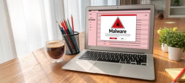 Cyber attacking concept. Malware alert showing on computer screen display scam and threat detection on computer system or online server to be removed snugly.