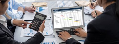 İş zekası ve veri analizi kavramı. Analizci ekibi laptop ekranında finansal veri analizi üzerinde çalışıyor. Etkili iş stratejik planlama için pazarlama göstergesi olarak. İçgörü