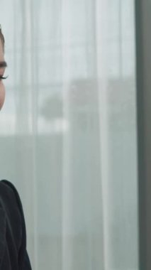 Masasında dizüstü bilgisayarla çalışan kulaklık ve mikrofon takan Asyalı müşteri destek operatörü. Hevesli kadın çalışanlar müşteri hizmetleri sunuyor, destekleyici çağrı merkezi temsilcisi müşterilere yardım ediyor.