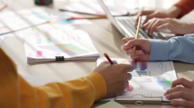 Girişimci şirket çalışanları birlikte çalışır, finansal veri raporlama ve planlama stratejisi, panorama videosundaki yaratıcı iş başarısı için pazarlama içeren renkli BI gösterge panelini analiz eder. Sinerjik