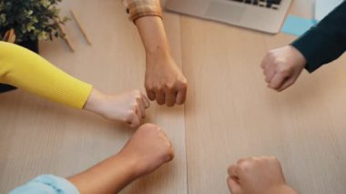 Çeşitli bireylerin canlı elleri, profesyonel bir ortamda ortaklığı ve takım çalışmasını sembolize ederek modern bir ofiste işbirliği ve destek jesti olarak birleşti. SACTR