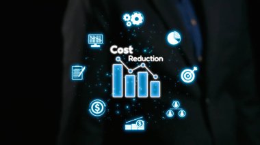 Takım elbiseli bir işadamı, şirketler için maliyet düşüşünü, finansal büyümeyi ve stratejik veri analizini sembolize eden dijital simgeleri gösteren karanlık bir arka plana karşı duruyor. Dörtgen