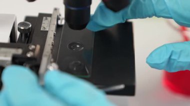 Bilimsel laboratuar araştırmacısı mikroskobik slayta kan örneği bırakır. Tıbbi muayene için ya da yeni teşhis aleti için. Mikrobiyolog, tıp çalışanı laboratuarda deney yapıyor. Ağır çekim. Katı.