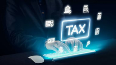 Bu resim, modern dijital vergi yönetimi ve e-dosyalama sistemlerini gösteren, parlayan bir vergi sembolü ve çeşitli finansal simgelerle birlikte bir klavyede yazan elleri gösteriyor. Dörtgen