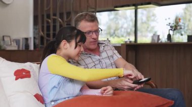 Dedem ve torunum TV 'de ilginç bir eğlence medyası izliyorlar. Genç nesil, yaşlı yaşlılara uzaktan kumanda teknolojisi kullanmayı öğretiyor. Nesiller arası uçurum aile bağını güçlendiriyor. Uyumsuzluk.